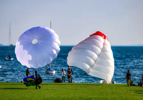 Several emergency parachutes at the dry landing site in Malcesine on Lake Garda after safety training.