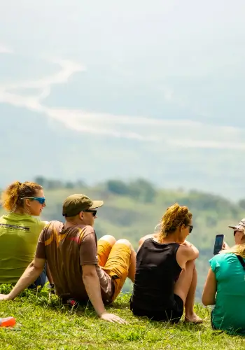 Group pilots sit relaxed at the launch site, without time pressure - our training approach for calm and thorough training.