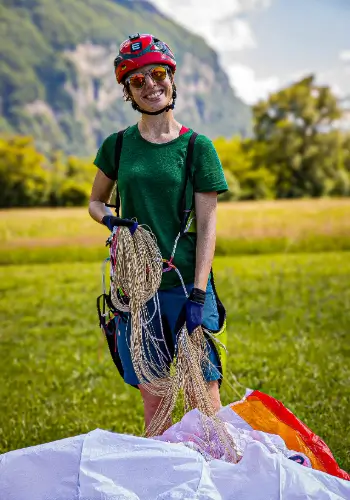 Pilot beaming after a successful paragliding flight during training at the touch and go paragliding school.