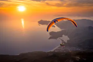 Paragliding flight during sunset over Ölüdeniz with touch and go paragliding.