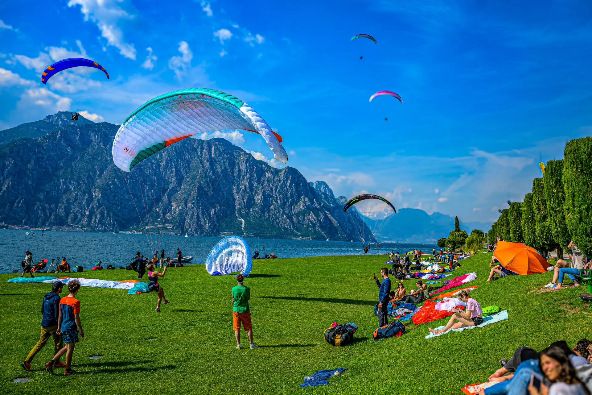 Paraglider lands after a successful training flight during safety training on Lake Garda.