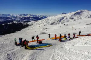 Paraglider pilots enjoy the season opening flight in Laax with touch and go paragliding.