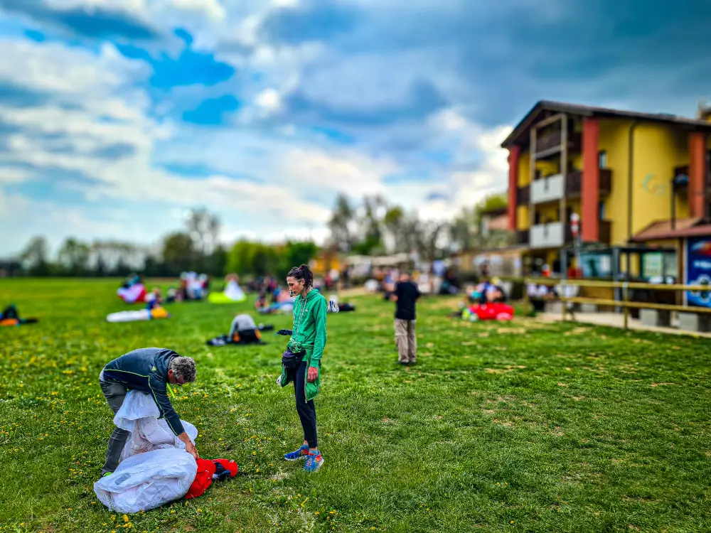Paraglider pilots enjoy long thermal flights over Bassano del Grappa with views of the Alps and the Italian countryside.