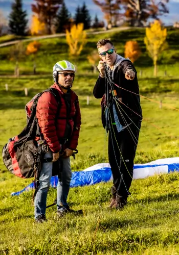 A flight instructor shows a student pilot how to control and handle the lines correctly on a team-building day - an important step in preparing for take-off.
