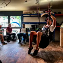 Gabor Kezi demonstrates the maneuvers during the maneuver briefing in the simulator during the training at touch and go Paragliding.