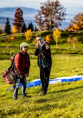 A flight instructor shows a student pilot how to control and handle the lines correctly - an important step in preparing for take-off.