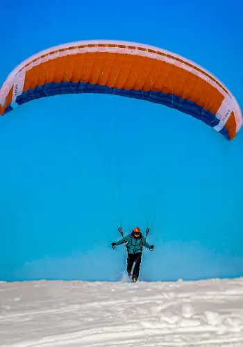 Pilot takes off with a Nova paraglider on the practice slope near Brunnen for a short flight - a perfect and unforgettable moment