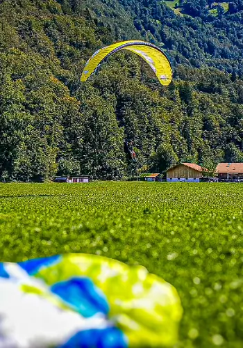 Paraglider on landing approach during paragliding training at touch and go Paragliding.