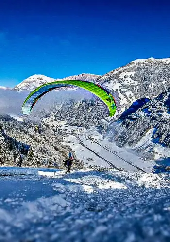 Student takes off for a high-altitude flight during paragliding training in Wolfenschiessen with touch and go paragliding.