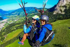 Tandem pilot flies with a passenger during the tandem flight as part of the training at touch and go Paragliding.
