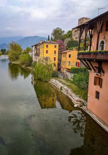 Paraglider pilots enjoy long thermal flights over Bassano del Grappa with views of the Alps and the Italian countryside.