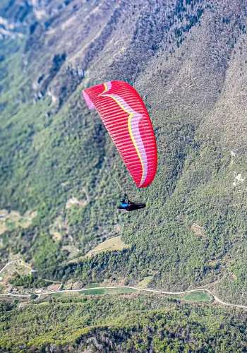 Paraglider pilots enjoy long thermal flights over Bassano del Grappa with views of the Alps and the Italian countryside.